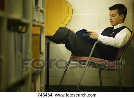Picture - Student studies in library. Fotosearch