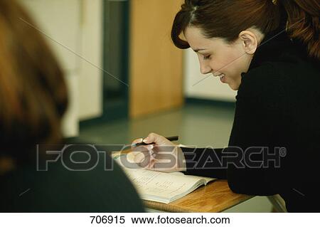 Stock Photography - Student taking notes in class. Fotosearch