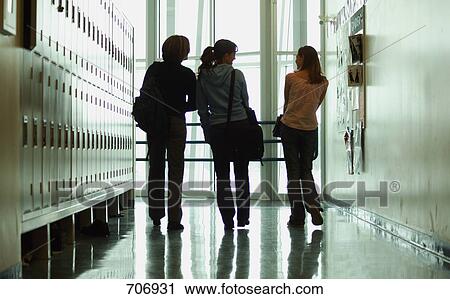 Stock Image - Students walk down hallway. Fotosearch