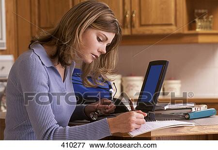 Stock Photo - Woman working from home. Fotosearch