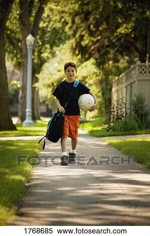 Child walks home from school View Large Photo Image Stock Photography - Child walks home from school. Fotosearch