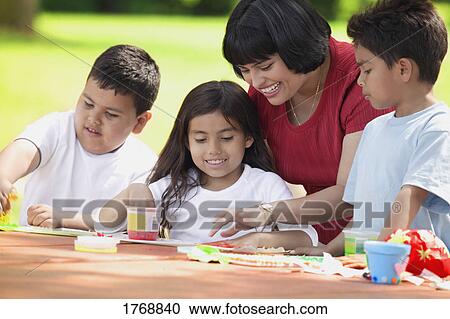 Family works on finger painting View Large Photo Image Stock Image - Family works on finger painting. Fotosearch