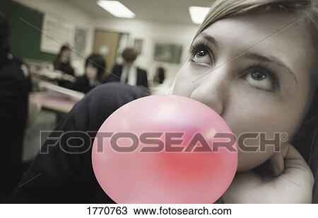 Female student blowing bubblegum View Large Photo Image Stock Image - Female student blowing bubblegum. Fotosearch