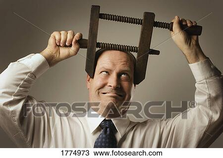 Man with head in vice View Large Photo Image Stock Image - Man with head in vice. Fotosearch