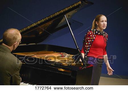 Singer being accompanied by piano View Large Photo Image Picture - Singer being accompanied by piano. Fotosearch