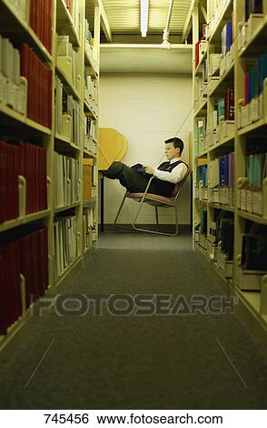 Student studies in library View Large Photo Image Stock Photograph - Student studies in library. Fotosearch