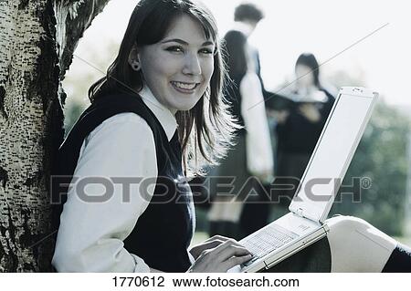 Stock Image - Student working on lap top. Fotosearch