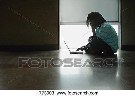 Stock Image - Student working on laptop. Fotosearch