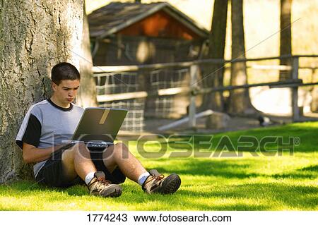 Teen boy working on lap top View Large Photo Image Stock Image - Teen boy working on lap top. Fotosearch