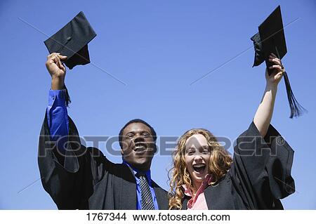 Picture - Two graduates celebrating. Fotosearch