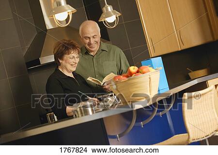 Picture - Couple cook together. Fotosearch