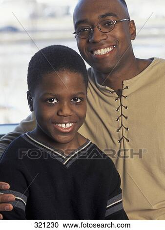 Stock Image - Father hugging son. Fotosearch