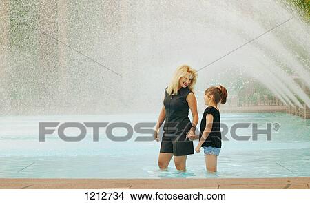 Mother and daughter in a wading pool View Large Photo Image Picture - Mother and daughter in a wading pool. Fotosearch