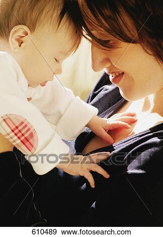 Stock Photo - Mother plays with baby. Fotosearch