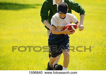 Stock Image - Playing football. Fotosearch