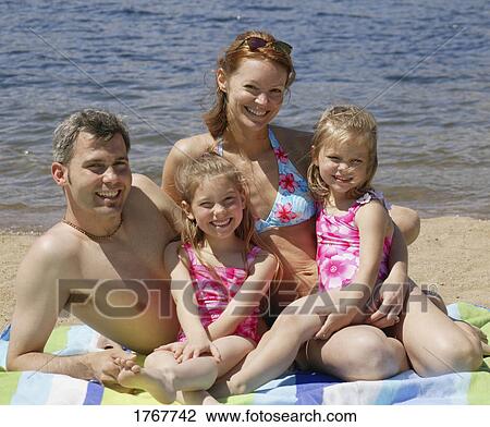 Stock Image - Portrait of a family at the beach. Fotosearch