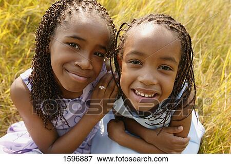 Two girls sit together View Large Photo Image Stock Photo - Two girls sit together. Fotosearch