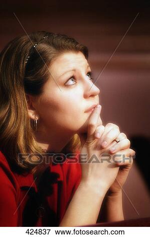 Stock Photo - Woman praying. Fotosearch