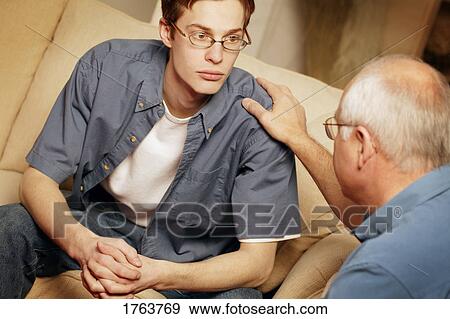 Young man getting counseling View Large Photo Image Stock Photo - Young man getting counseling. Fotosearch