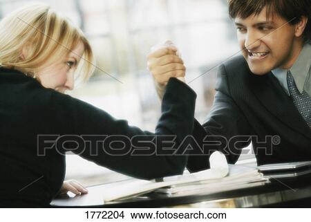 Business couple arm westling View Large Photo Image Picture - Business couple arm westling. Fotosearch