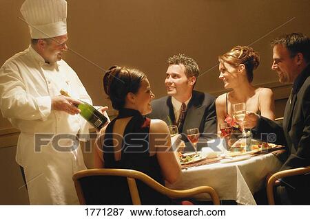 Stock Photo - Couples having dinner in a restaurant. Fotosearch