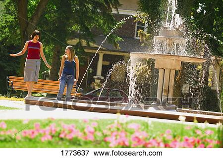 Girls at water fountain View Large Photo Image Stock Photo - Girls at water fountain. Fotosearch