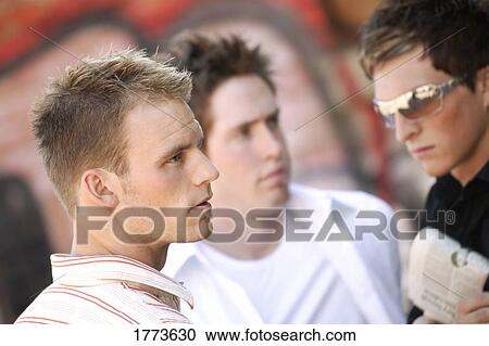 Stock Image - Group of guys waiting. Fotosearch