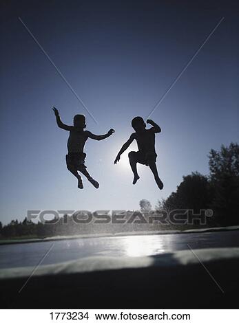 Jumping on a wet trampoline View Large Photo Image Picture - Jumping on a wet trampoline. Fotosearch