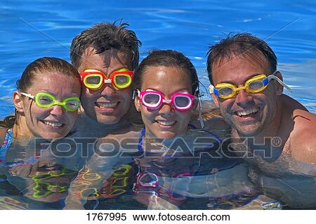 Portrait of Happy group in swimming pool View Large Photo Image Stock Photography - Portrait of Happy group in swimming pool. Fotosearch