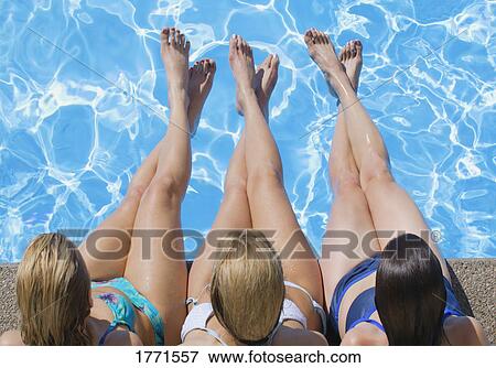 Three girls at side of pool View Large Photo Image Stock Photo - Three girls at side of pool. Fotosearch