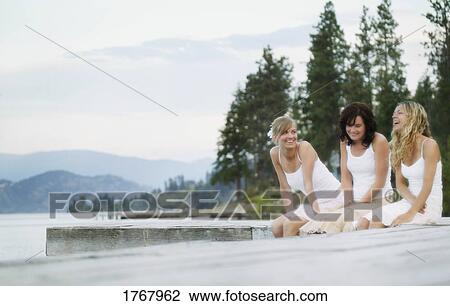 Three women enjoy a laugh View Large Photo Image Stock Image - Three women enjoy a laugh. Fotosearch