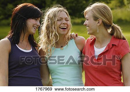 Three women enjoy a laugh View Large Photo Image Stock Photo - Three women enjoy a laugh. Fotosearch