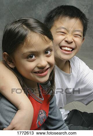 Stock Image - Two children having a giggle. Fotosearch