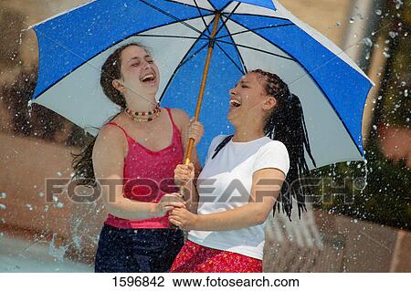 Two friends under umbrella View Large Photo Image Stock Image - Two friends under umbrella. Fotosearch