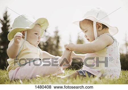 Two girls sit together View Large Photo Image Stock Photo - Two girls sit together. Fotosearch