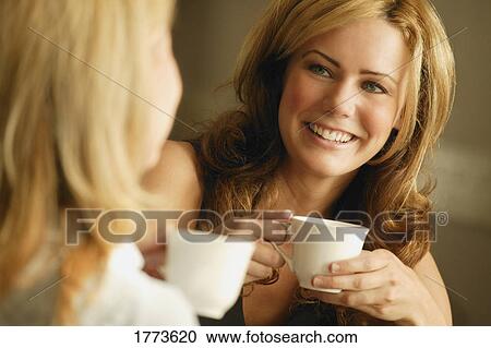 Two women having coffee View Large Photo Image Stock Image - Two women having coffee. Fotosearch