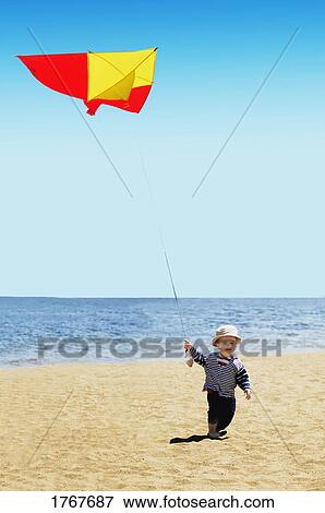 Stock Photo - A child flies a kite. Fotosearch