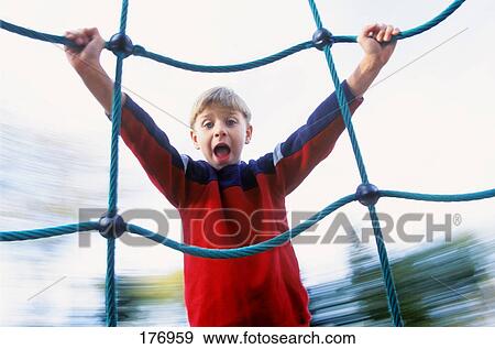 Stock Photo - Boy on playground ride. Fotosearch