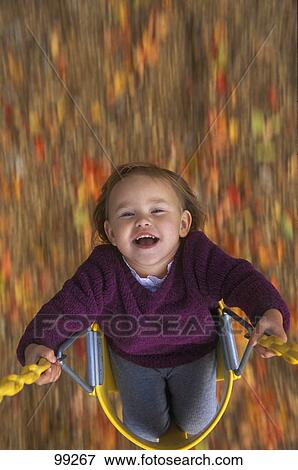 Stock Photo - Child on swing. Fotosearch