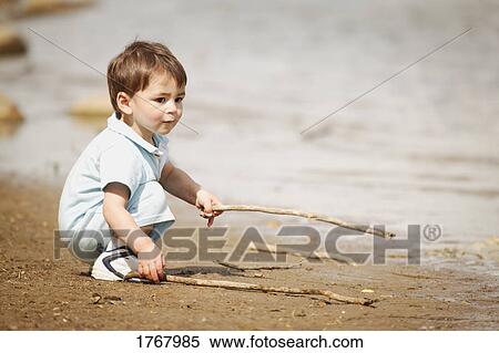 Child plays with sticks View Large Photo Image Stock Photography - Child plays with sticks. Fotosearch