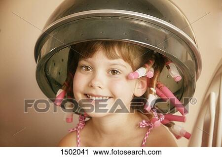 Stock Image - Child with rollers in her hair. Fotosearch