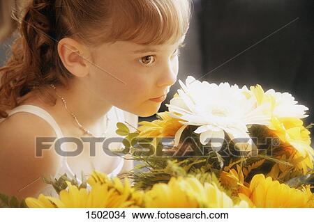 Flower girl smells bouquet View Large Photo Image Picture - Flower girl smells bouquet. Fotosearch