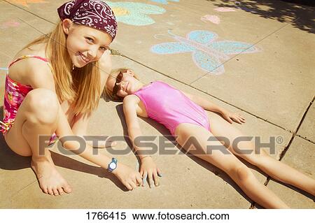 Girls play with sidewalk chalk View Large Photo Image Stock Photography - Girls play with sidewalk chalk. Fotosearch