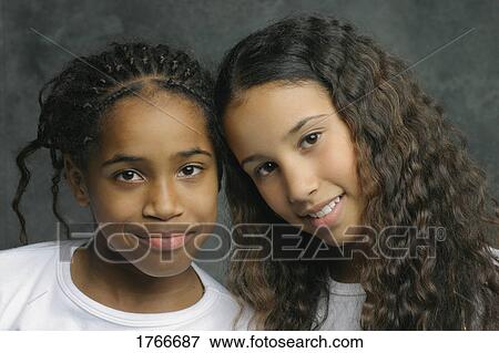 Stock Photo - Portrait of two young girls. Fotosearch
