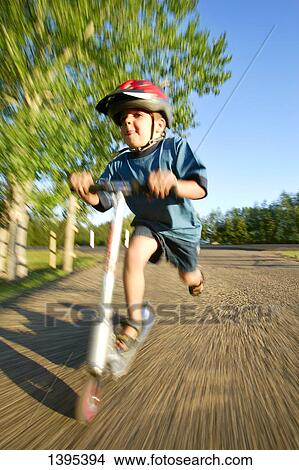 Picture - Pushing a scooter. Fotosearch