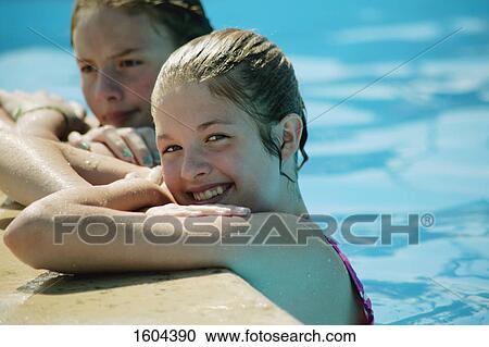 Two girls in swimming pool View Large Photo Image Stock Image - Two girls in swimming pool. Fotosearch