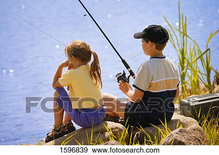 Two kids fishing View Large Photo Image Stock Photo - Two kids fishing. Fotosearch