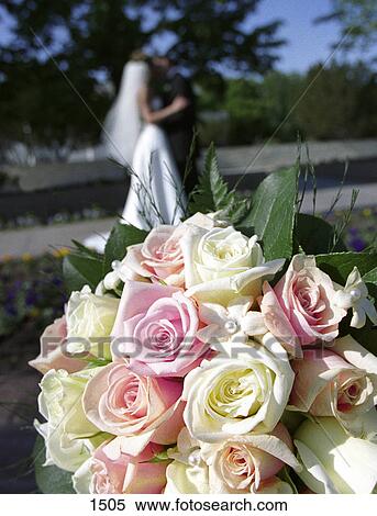 Bridal bouquet with bride and groom in background View Large Photo Image Stock Photography - Bridal bouquet with bride and groom in background. Fotosearch
