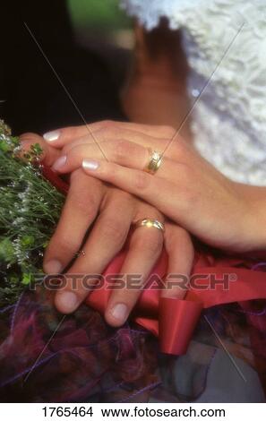 Picture - Bride and Groom Showcasing their rings. Fotosearch