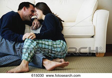 Couple cuddling on floor View Large Photo Image Stock Image - Couple cuddling on floor. Fotosearch